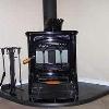Hearthstone Craftsbury woodstove installed with a Yoder Hearth Classics stove board 