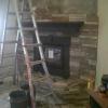 fireplace installation - stack stone veneer application in progress